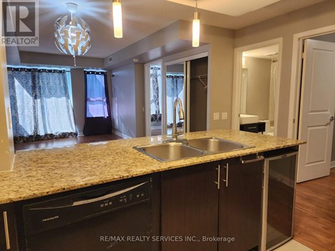 A kitchen with granite countertops and stainless steel appliances.