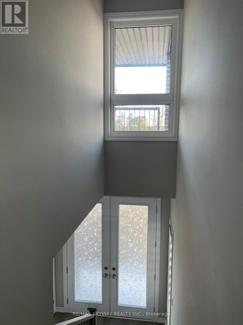 A window in a room with a view of a building outside.