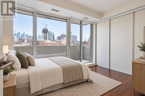 A bedroom with a large bed and a view of the city.