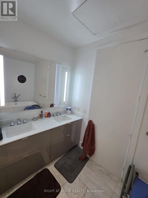 A bathroom with a sink, mirror, and towel.
