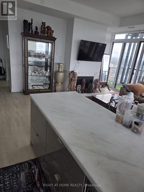 A kitchen counter with a white marble top and a cabinet underneath.