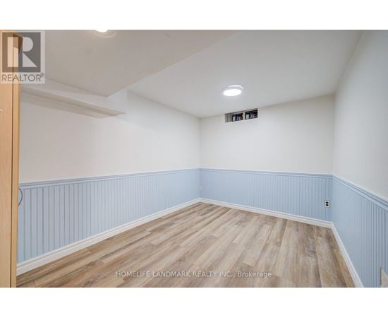 A room with wooden flooring and white walls.