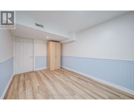 A room with a wooden floor and a white door.