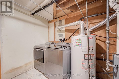 A wall-mounted water heater and a tankless water heater are installed in a basement.