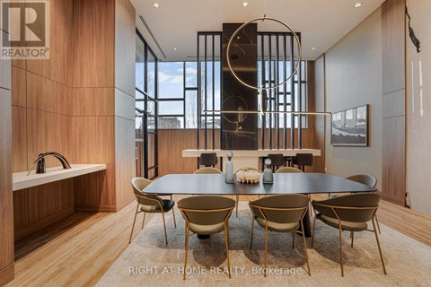A modern dining room with a large table and chairs.