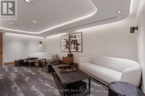 A modern living room with a white couch and a coffee table.