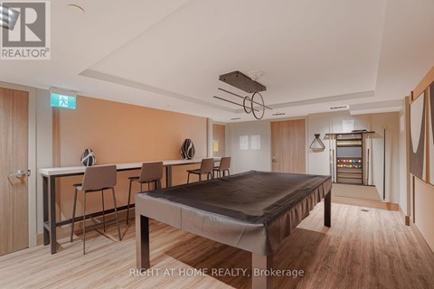 A bedroom with a bed, desk, and chairs.