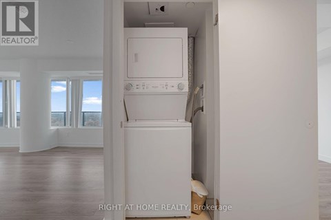 A white dishwasher is in a kitchen with a window.