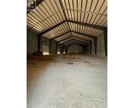 A long, narrow, covered walkway with a white floor.