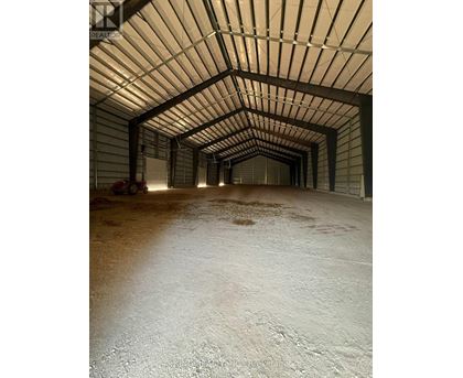 A long, narrow, covered walkway with a white floor.