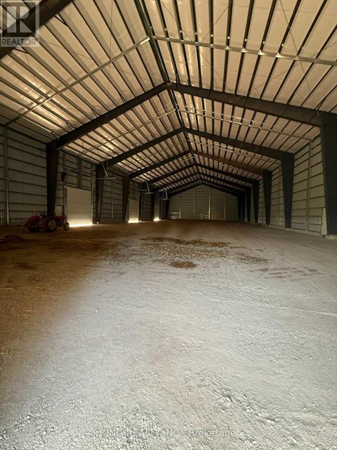 A long, narrow, covered walkway with a white floor.