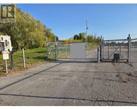 A gate blocks the entrance to a parking lot.