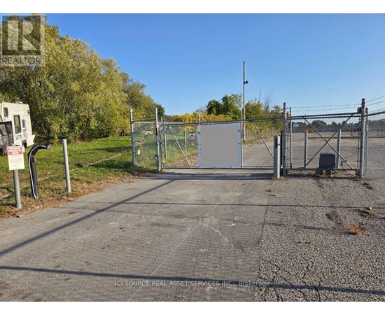 A gate blocks the entrance to a parking lot.
