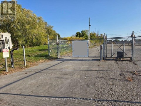 A gate blocks the entrance to a parking lot.