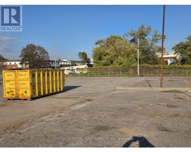 A yellow container with the number 1470 on it is placed in a parking lot.