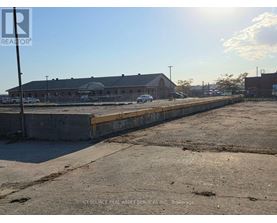 A sunny day at a construction site with a building in the background.