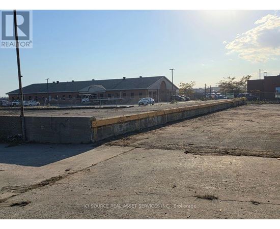 A sunny day at a construction site with a building in the background.