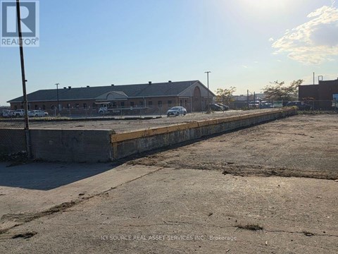 A sunny day at a construction site with a building in the background.