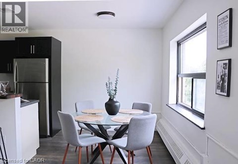 A dining room with a glass table and chairs.