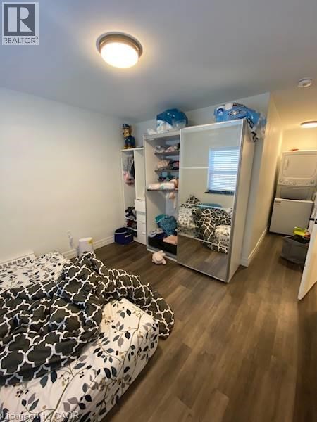 A bedroom with a bed, a wardrobe, and a small table.