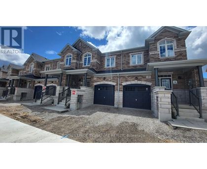 A row of new houses with garages in front.