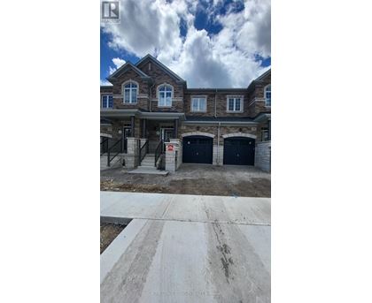 A large house with a garage is under construction.