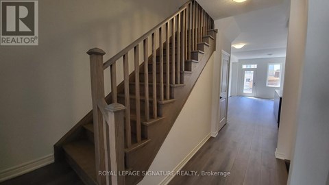 A staircase with a wooden banister and steps.