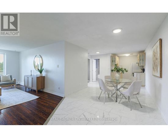 A white dining room with a glass table and chairs.
