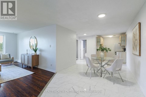 A white dining room with a glass table and chairs.