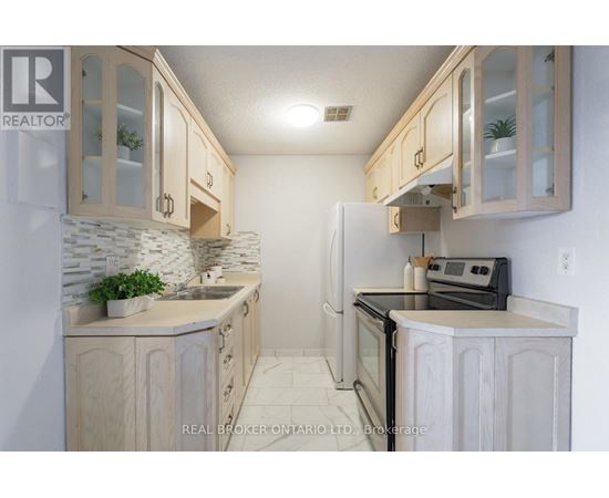 A kitchen with wooden cabinets and a black stove top oven.