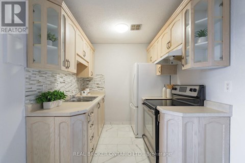 A kitchen with wooden cabinets and a black stove top oven.