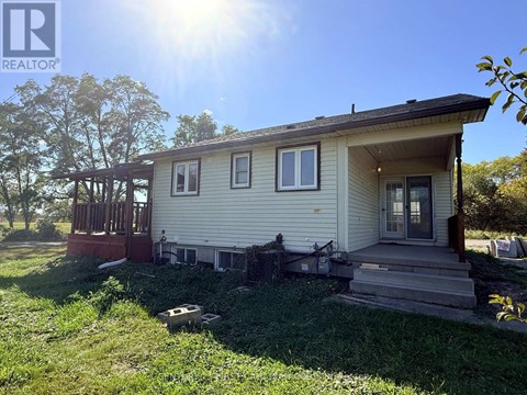 A house with a porch and a covered deck is for sale.
