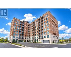 A large brick apartment building with a clear blue sky above.