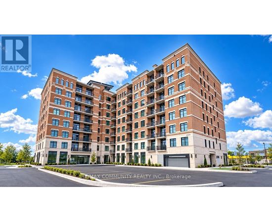 A large brick apartment building with a clear blue sky above.