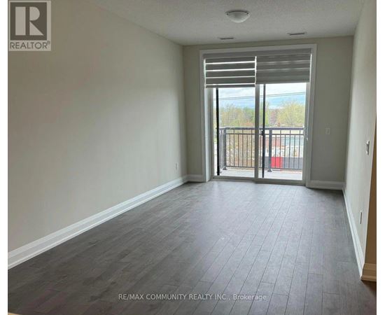 A room with a sliding glass door leading to a balcony.