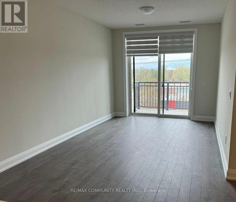 A room with a sliding glass door leading to a balcony.