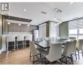 A dining room with a table and chairs.
