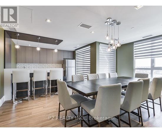 A dining room with a table and chairs.