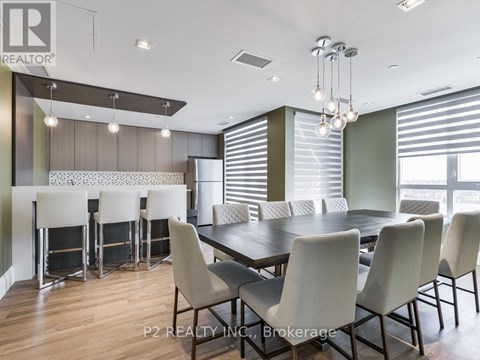 A dining room with a table and chairs.