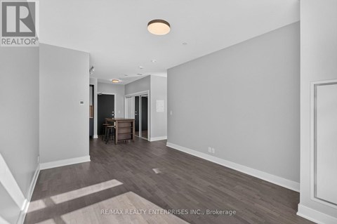 A spacious room with a dining table and chairs is shown.