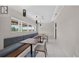 A dining area with a table and chairs.