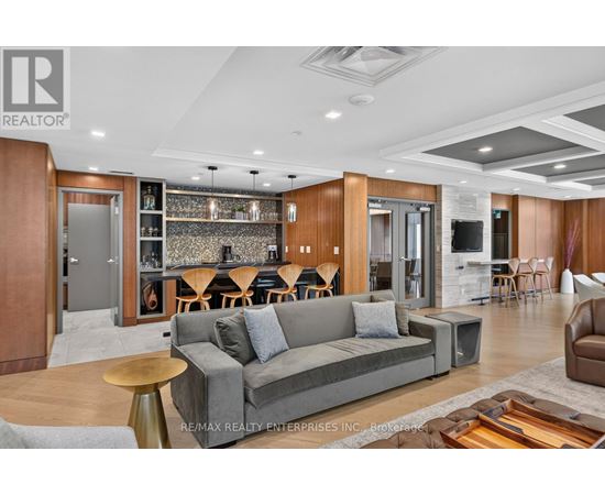 A modern living room with a grey sofa and wooden accents.