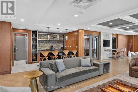 A modern living room with a grey sofa and wooden accents.