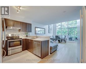 A modern kitchen with wooden cabinets and stainless steel appliances.