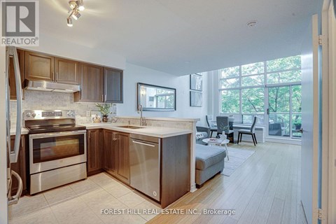 A modern kitchen with wooden cabinets and stainless steel appliances.