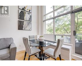A dining room with a glass table and chairs.