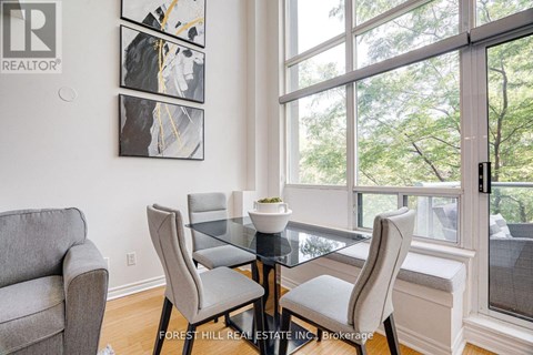A dining room with a glass table and chairs.