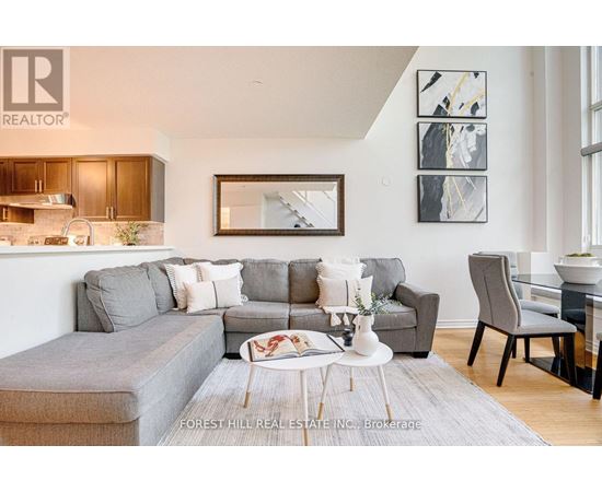 A living room with a grey couch and a coffee table.