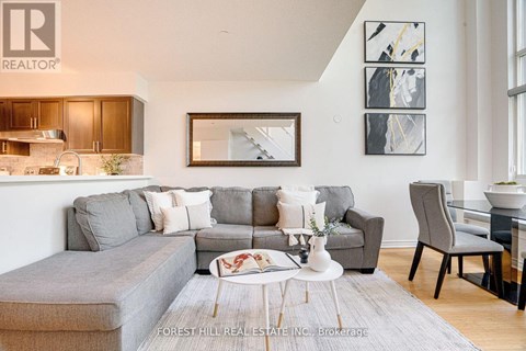 A living room with a grey couch and a coffee table.