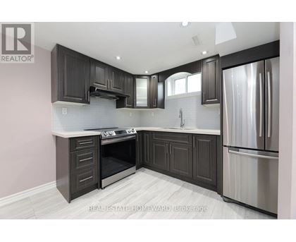 A modern kitchen with dark wood cabinets and stainless steel appliances.